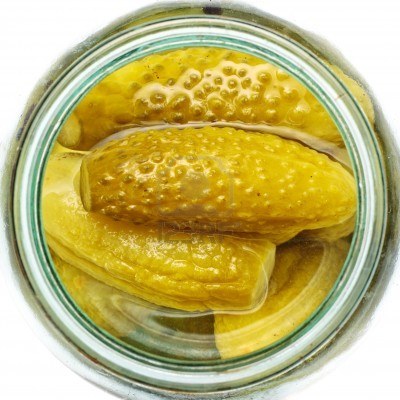 c 9040087-opened-glass-jar-of-green-pickled-cucumbers